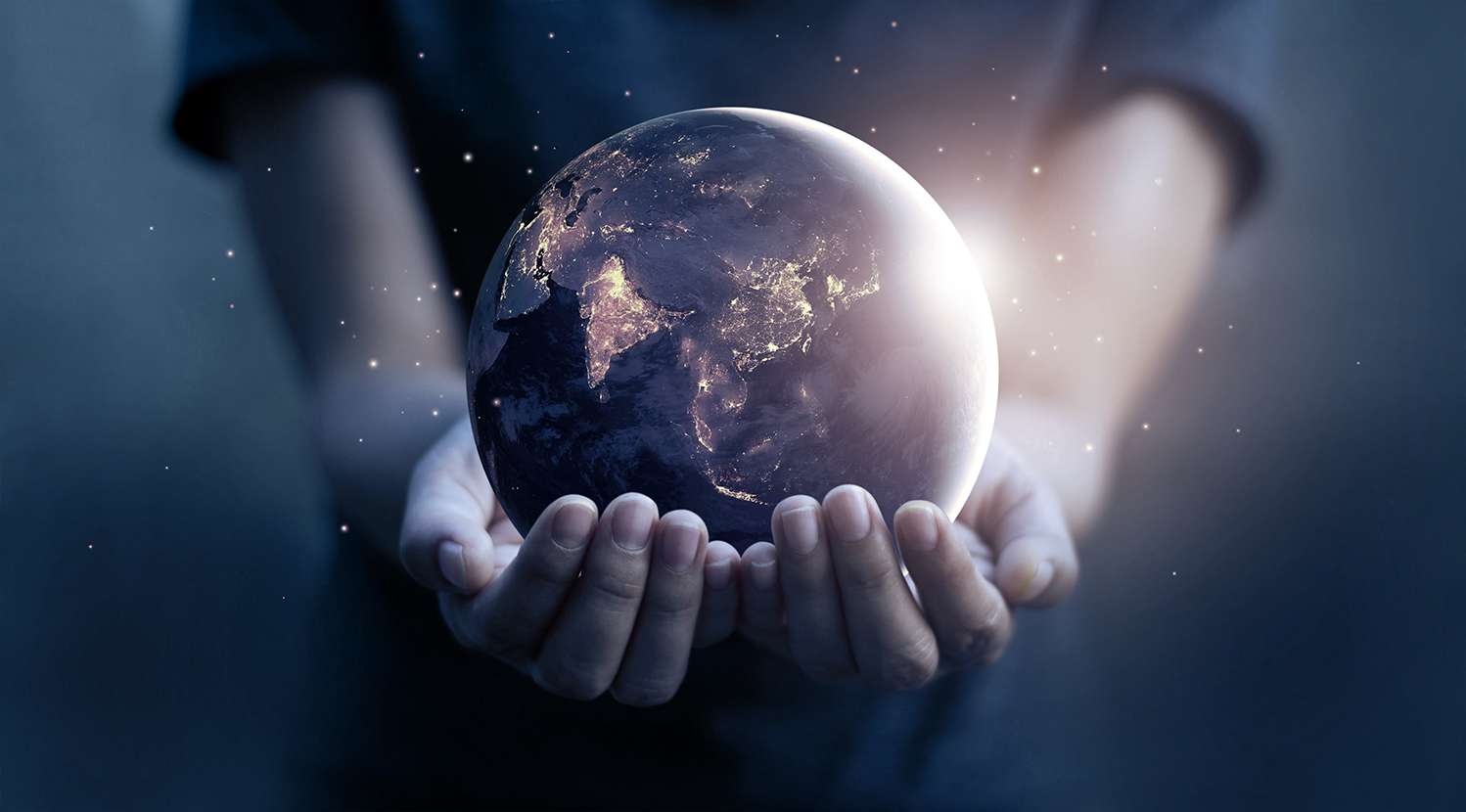 An image of Earth being held in a person's hands.